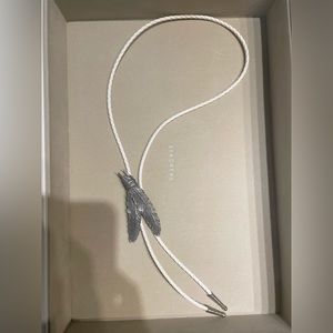 Tied Feathers Bolo Tie on White Braided Leather